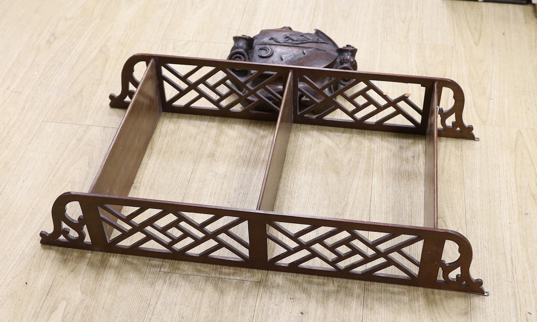 A Chippendale style open hanging shelf and an 18th/19th century carved mahogany armorial shield, shelves 80cm x 40cm